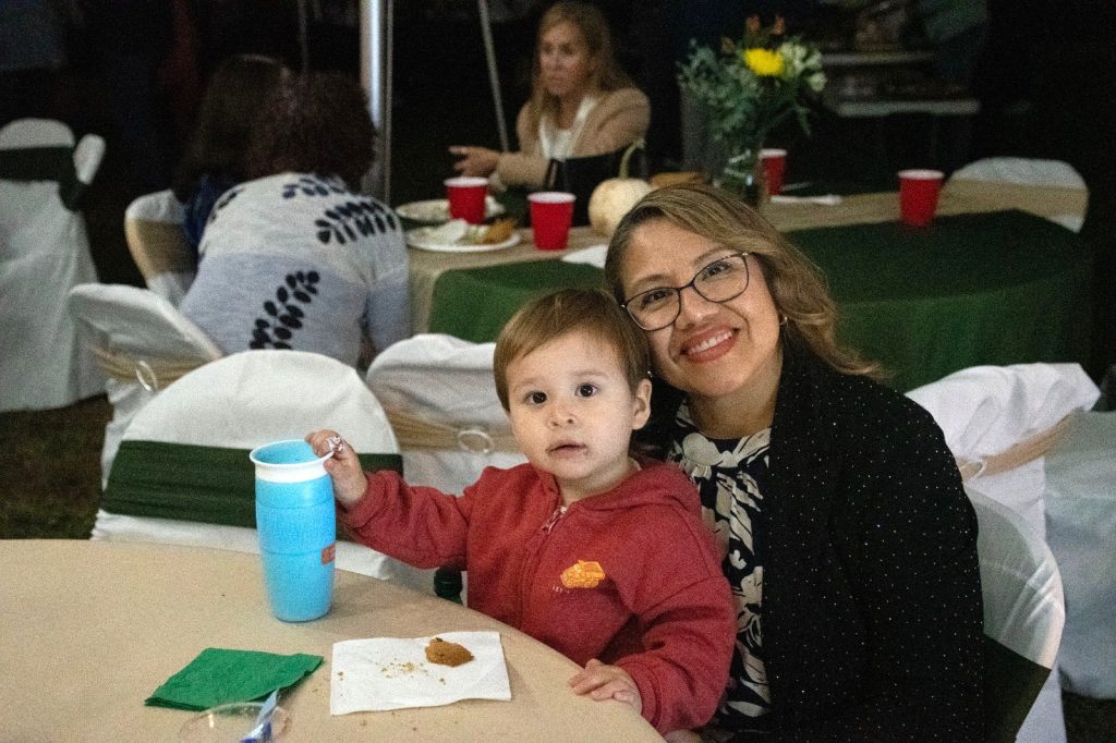 A mother and her young son at a dinner table